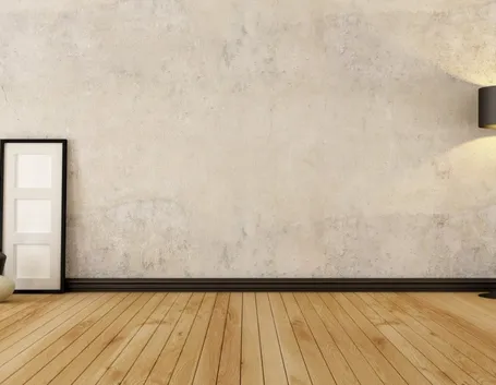 Muro di una stanza rivestito da intonaco